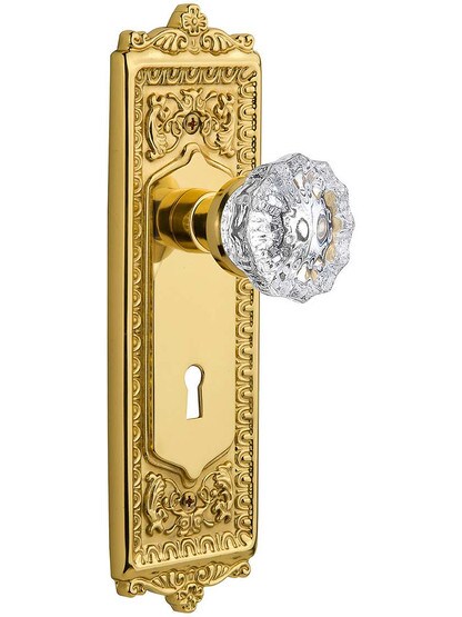 Egg and Dart Door Set with Fluted-Crystal Glass Knobs and Keyhole Single Dummy in Polished Brass.